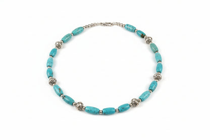 Turquoise beaded necklace on a white surface