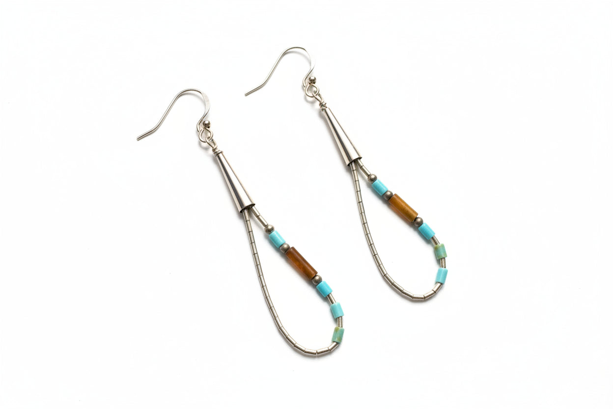 Earrings with decorative beads on a light gray background