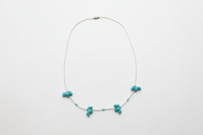 Necklace with turquoise beads on a white background