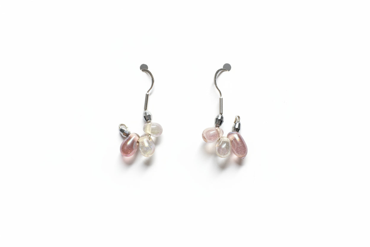 Pair of earrings with gemstones on a white surface