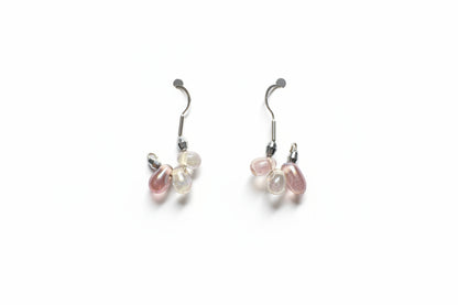 Pair of earrings with gemstones on a white surface
