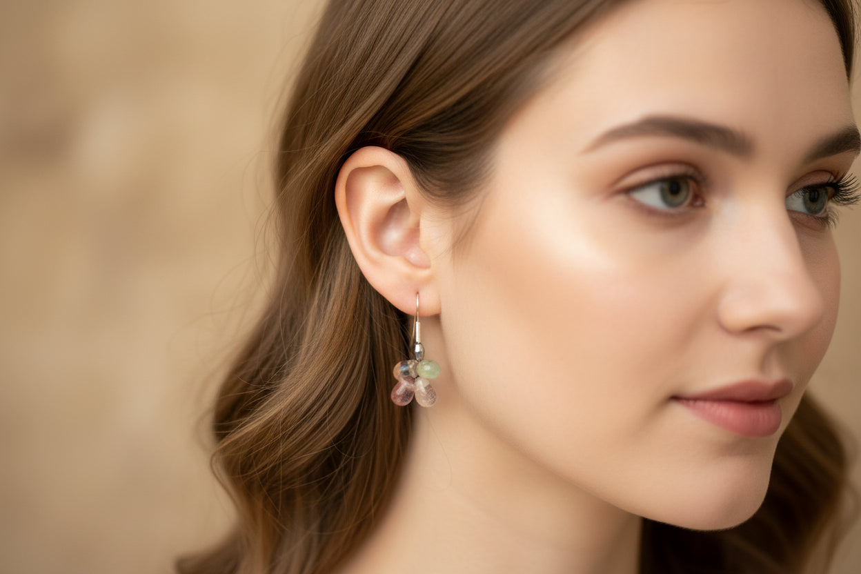 Pair of earrings with gemstones on a light gray background
