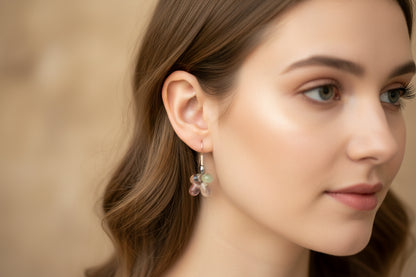 Pair of earrings with gemstones on a light gray background