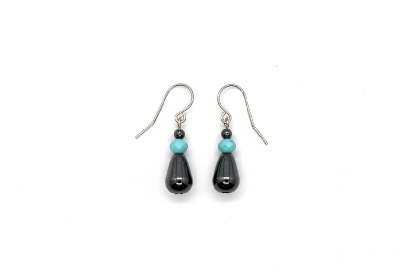 Pair of black earrings on a gray background