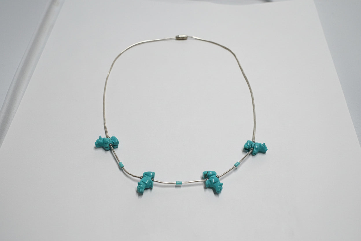 Necklace with turquoise beads on a light gray background