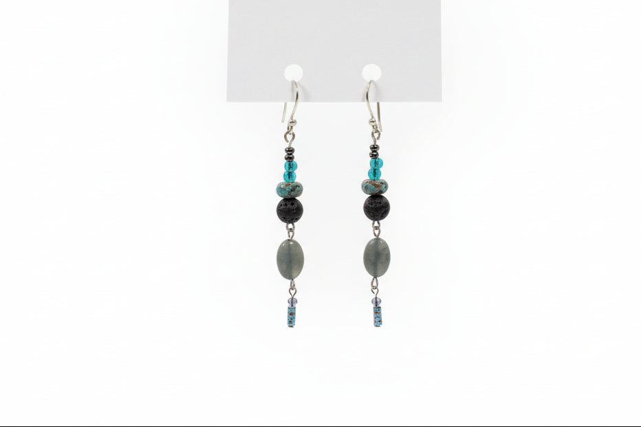 Pair of beaded earrings on a white card with a plain background