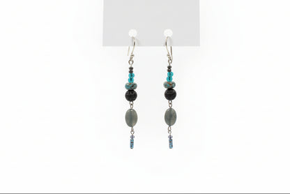 Pair of beaded earrings on a white card with a plain background