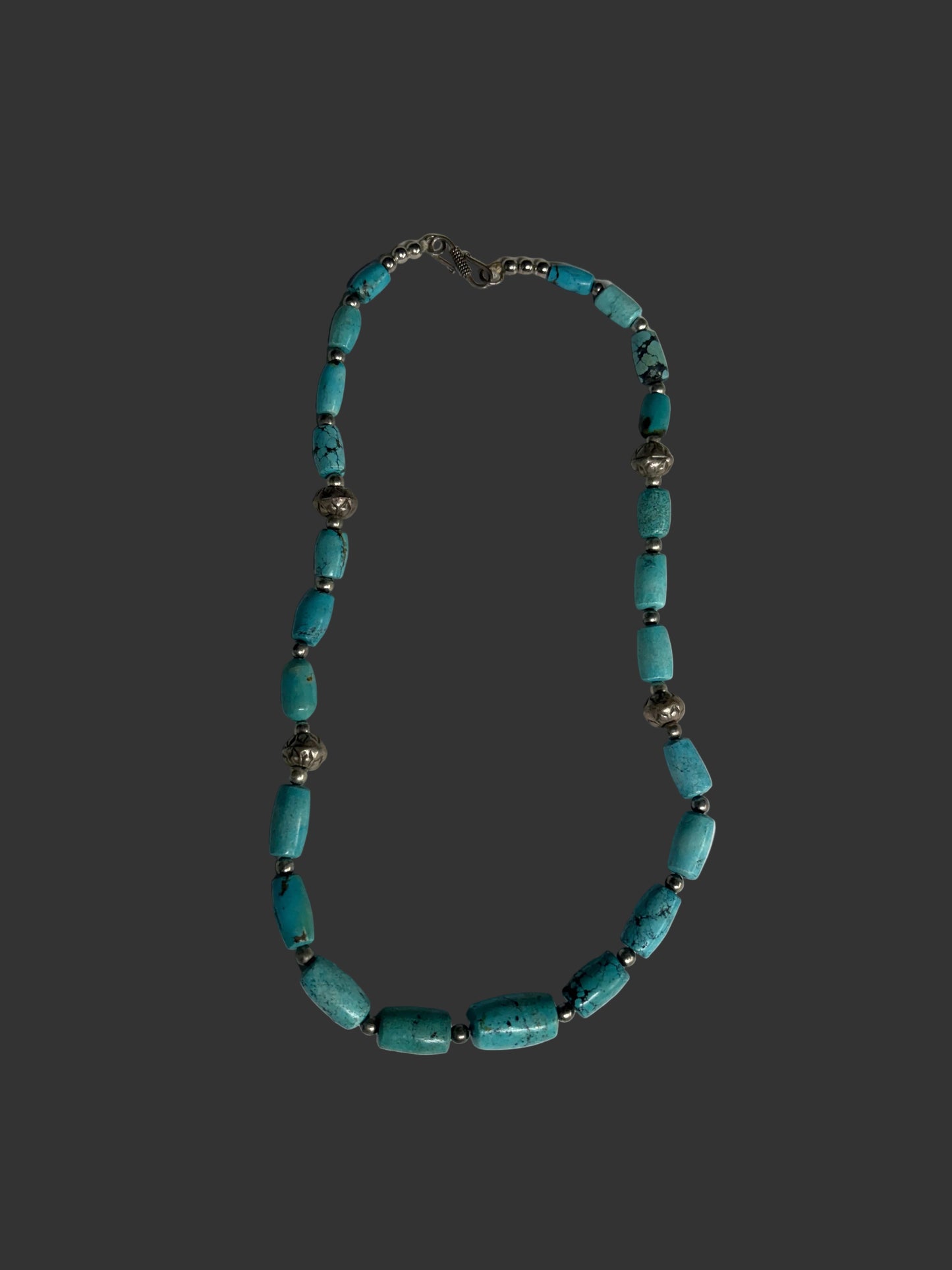 Necklace with turquoise beads on a white tray