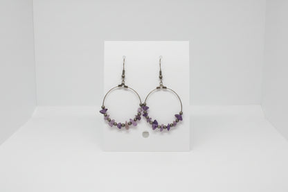 card with hoop earrings on a plain background