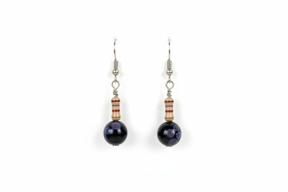 Pair of earrings with dark beads on a white card