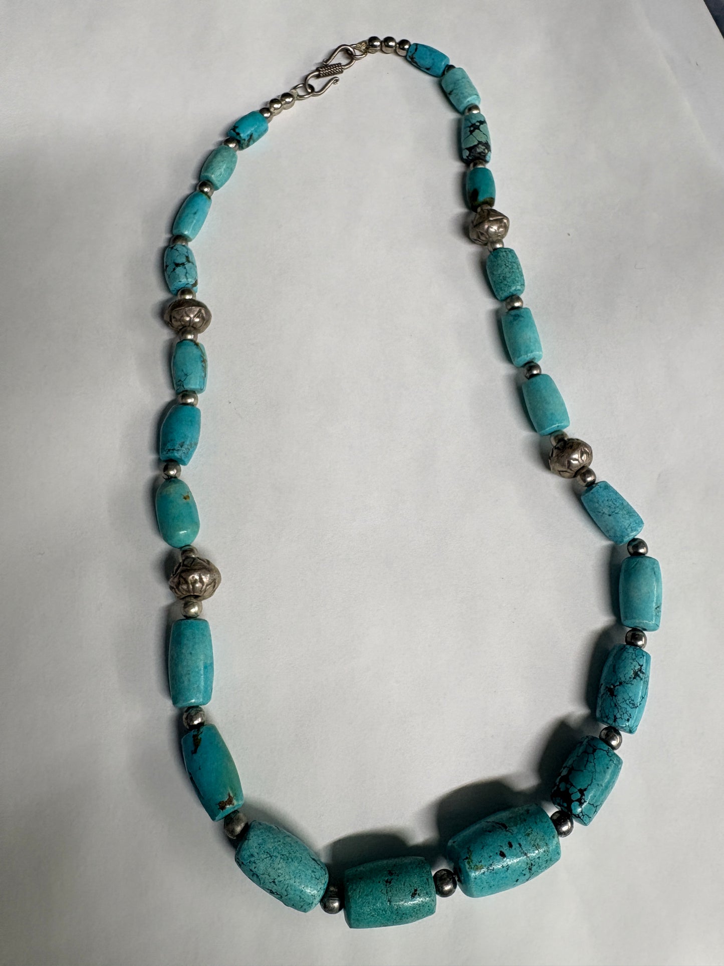 Turquoise beaded necklace on a white background