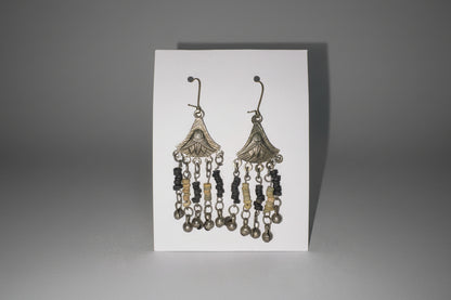 Decorative earrings on a white card