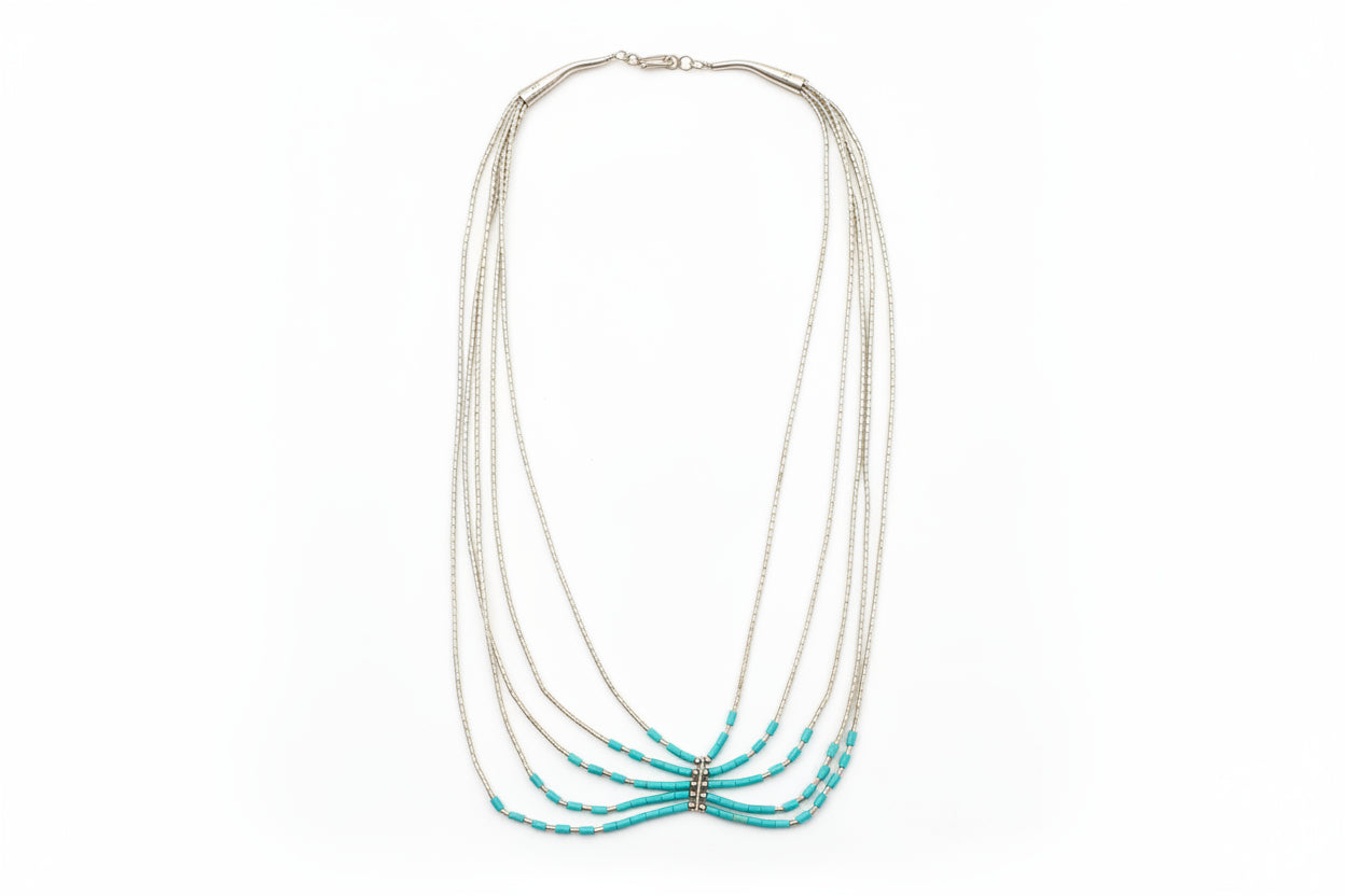 Necklace with turquoise beads on a light gray background