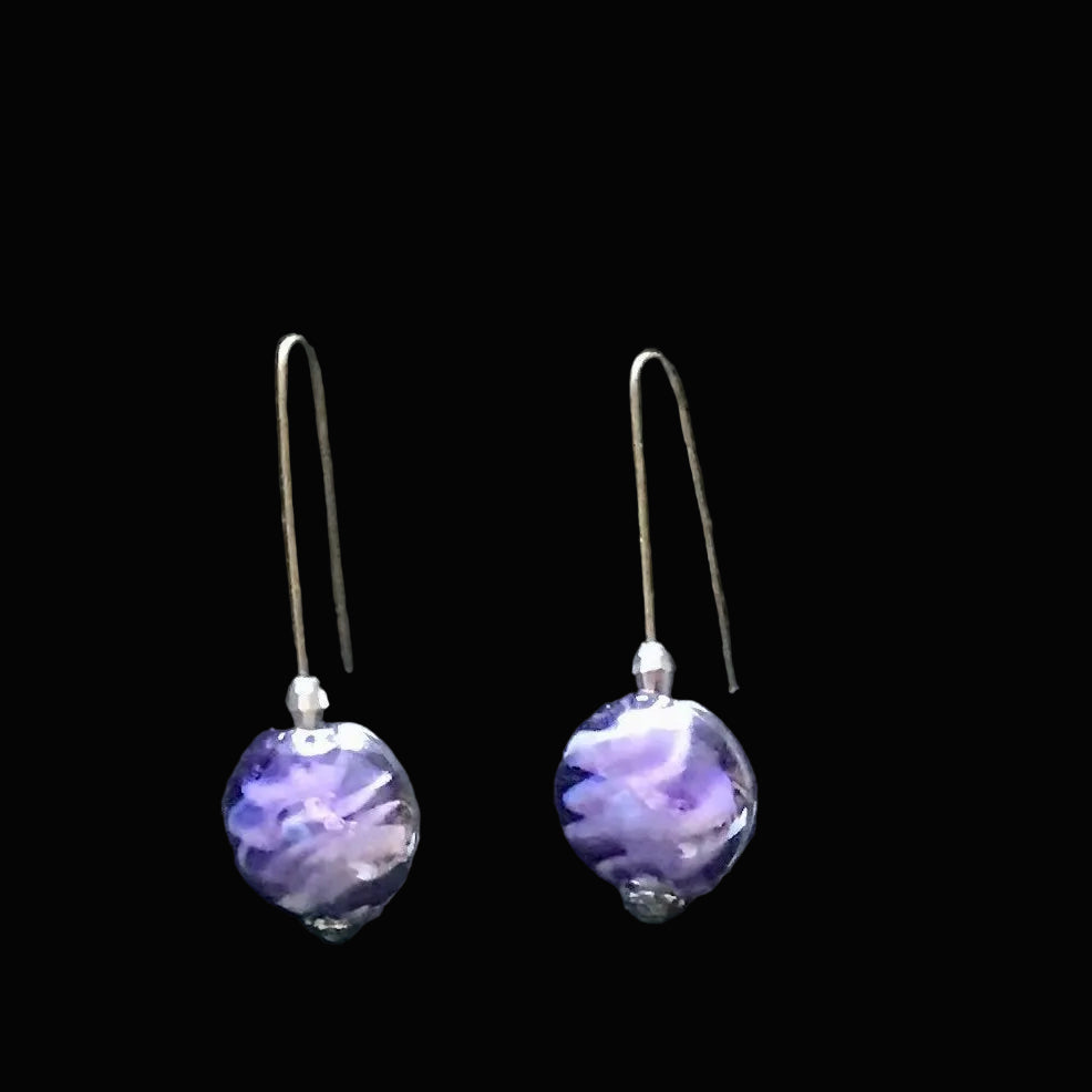 Purple glass bead earrings on a black background